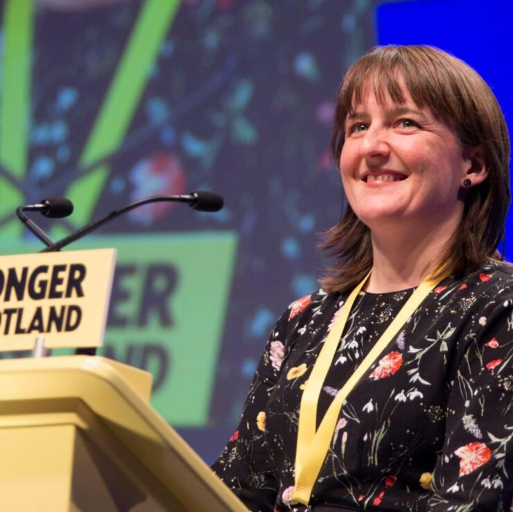 Maree Todd MSP standing at a lectern during a conference