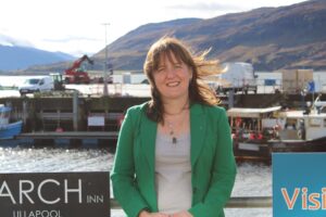 Maree Todd standing against railings at Ullapool Harbour