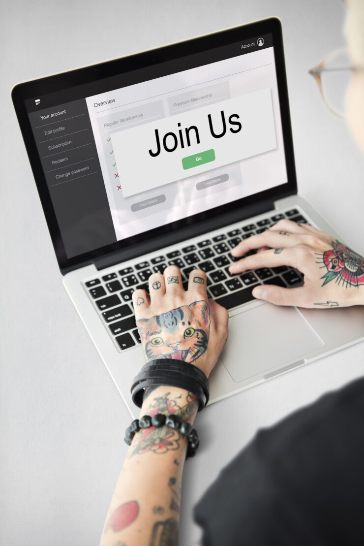 Laptop with "Join Us" on the screen