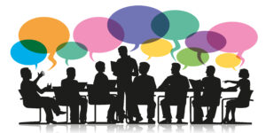 group sitting round a table discussing